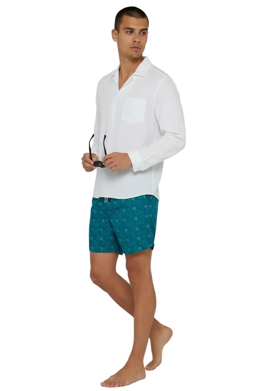 Red Sea Coast teal swim shorts with white shirt, walking view