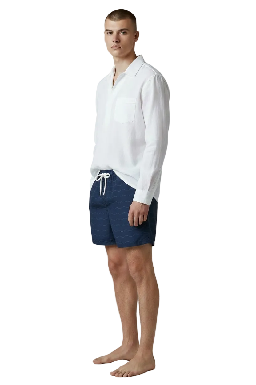 Classic Wave navy swim shorts with white linen shirt, side view